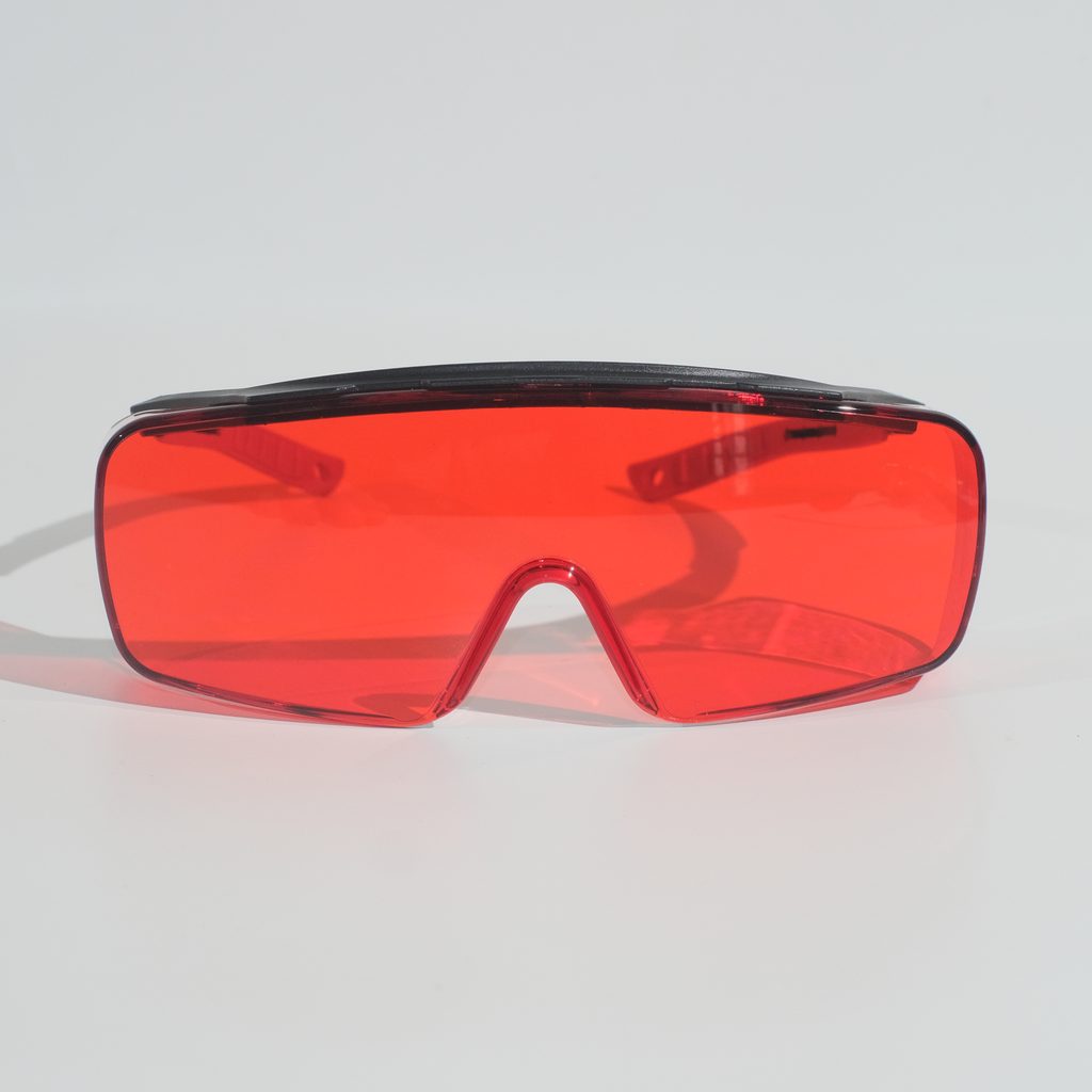 Lyfe Max Deep Red fit-over glasses seen from the front: a single wraparound red lens under a black brow bar.